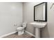 Modern bathroom with pedestal sink, toilet, and framed mirror at 21023 N 58Th Way, Phoenix, AZ 85054