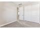 Simple bedroom with neutral walls, carpeting and double doors to closet at 21023 N 58Th Way, Phoenix, AZ 85054