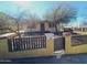 Ranch-style home with fenced yard and mature trees at 211 W Kiser St, Superior, AZ 85173