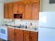 Kitchen features wood cabinets and white appliances at 211 W Kiser St, Superior, AZ 85173