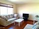 Living room with hardwood floors, comfy couch, and TV at 211 W Kiser St, Superior, AZ 85173