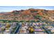 Aerial view of homes, golf course, and mountain range at 2164 W Muirfield Dr, Anthem, AZ 85086