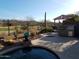 Outdoor kitchen and patio area with pool and mountain views at 2164 W Muirfield Dr, Anthem, AZ 85086