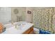 Clean bathroom with lemon-themed shower curtain and single sink vanity at 2164 W Muirfield Dr, Anthem, AZ 85086