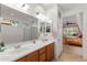 Double vanity bathroom with a large mirror and shower at 2164 W Muirfield Dr, Anthem, AZ 85086