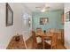 Bright dining room with wood table and chairs, wood floors, and view to kitchen at 2164 W Muirfield Dr, Anthem, AZ 85086