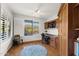 Bright home office with built-in desk and wood cabinets at 2164 W Muirfield Dr, Anthem, AZ 85086