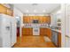 Well-equipped kitchen featuring wood cabinets and granite countertops at 2164 W Muirfield Dr, Anthem, AZ 85086