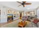 Open living room with built-in shelving, hardwood floors, and a view of the kitchen at 2164 W Muirfield Dr, Anthem, AZ 85086