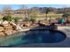 Relaxing kidney-shaped pool with waterfall feature and mountain views at 2164 W Muirfield Dr, Anthem, AZ 85086