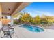 Relaxing kidney shaped pool with waterfall feature at 2164 W Muirfield Dr, Anthem, AZ 85086