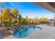 Inviting kidney-shaped pool with waterfall feature at 2164 W Muirfield Dr, Anthem, AZ 85086