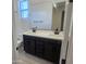 Bathroom boasts a double sink vanity with modern fixtures and neutral tile at 22311 W Monona Ln, Surprise, AZ 85387
