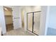 Bathroom with a glass shower and an open walk-in closet at 22311 W Monona Ln, Surprise, AZ 85387