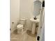 Powder room with pedestal sink, oval mirror, and wood-look floors at 22311 W Monona Ln, Surprise, AZ 85387