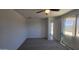 Bedroom with a ceiling fan, window, carpet and ensuite access at 22311 W Monona Ln, Surprise, AZ 85387