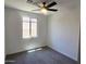 Cozy bedroom featuring a ceiling fan, window, and neutral carpet at 22311 W Monona Ln, Surprise, AZ 85387