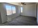 Bedroom with carpet, large window, and door to the outside at 22311 W Monona Ln, Surprise, AZ 85387