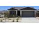 Charming single-story home featuring a neutral color palette, stone accents, and a well-manicured front yard at 22311 W Monona Ln, Surprise, AZ 85387