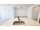 Modern kitchen with an island, quartz countertops, and stainless steel sink at 22311 W Monona Ln, Surprise, AZ 85387