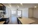 Modern kitchen featuring dark wood cabinets, stainless steel appliances, a center island, and wood look tile at 22311 W Monona Ln, Surprise, AZ 85387