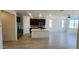 Modern kitchen featuring dark wood cabinets, stainless steel appliances, a center island, and wood look tile at 22311 W Monona Ln, Surprise, AZ 85387