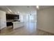 Modern kitchen featuring dark wood cabinets, stainless steel appliances, a center island, and wood look tile at 22311 W Monona Ln, Surprise, AZ 85387