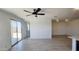 Open concept living area featuring tile flooring, a ceiling fan, and natural light at 22311 W Monona Ln, Surprise, AZ 85387