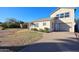 Light-colored house with a neat lawn, driveway, and mature shrubs at 2232 N 13Th St, Phoenix, AZ 85006