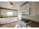 Bright kitchen features white cabinets, gas range, and microwave at 2232 N 13Th St, Phoenix, AZ 85006