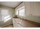 White kitchen cabinets, double sink, and a window overlooking the yard at 2232 N 13Th St, Phoenix, AZ 85006