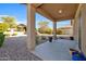 Covered patio with view of gravel backyard and neighboring homes at 22424 W La Pasada Blvd, Buckeye, AZ 85326