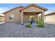 Home's back exterior, showcasing a covered patio and gravel yard at 22424 W La Pasada Blvd, Buckeye, AZ 85326