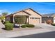 Tan one-story house with two-car garage and landscaping at 22424 W La Pasada Blvd, Buckeye, AZ 85326