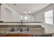 Kitchen island with granite countertop and double sink at 22424 W La Pasada Blvd, Buckeye, AZ 85326