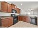 Spacious kitchen with granite countertops and dark wood cabinets at 22424 W La Pasada Blvd, Buckeye, AZ 85326