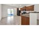 Kitchen with granite countertops, dark wood cabinets, and black appliances at 22424 W La Pasada Blvd, Buckeye, AZ 85326