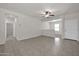 Neutral-toned living area with tile flooring and access to other rooms at 22424 W La Pasada Blvd, Buckeye, AZ 85326