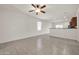 Bright living room with ceiling fan and tile flooring at 22424 W La Pasada Blvd, Buckeye, AZ 85326