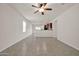 Spacious living room with tile floors and ceiling fan at 22424 W La Pasada Blvd, Buckeye, AZ 85326