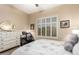 Guest bedroom with a queen bed, dresser and window shutters at 22808 N Los Gatos Dr, Sun City West, AZ 85375