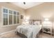 Guest bedroom with a queen bed, nightstands, and window shutters at 22808 N Los Gatos Dr, Sun City West, AZ 85375