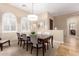 Bright dining room with arched windows and a modern chandelier at 22808 N Los Gatos Dr, Sun City West, AZ 85375