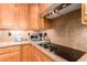 Kitchen detail showing cooktop, granite counters, and stainless steel appliances at 22808 N Los Gatos Dr, Sun City West, AZ 85375