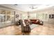 Bright living room featuring a comfortable leather sectional and large windows at 22808 N Los Gatos Dr, Sun City West, AZ 85375