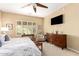 Main bedroom with king bed, large dresser, and ceiling fan at 22808 N Los Gatos Dr, Sun City West, AZ 85375