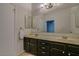 Double vanity bathroom with dark brown cabinets and a large mirror at 2315 W Union Hills Dr # 112, Phoenix, AZ 85027