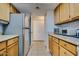 Kitchen with wood cabinets, stainless steel appliances, and tile floor at 2315 W Union Hills Dr # 112, Phoenix, AZ 85027