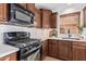 Modern gas cooktop and microwave in a kitchen with white subway tile backsplash at 2613 E Bart St, Gilbert, AZ 85295