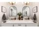 Modern bathroom with double vanity and arch mirrors at 2649 N Granite Reef Rd, Scottsdale, AZ 85257